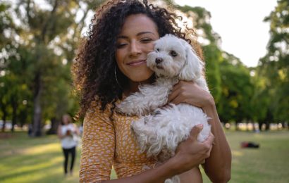 young-lady-cuddling-a-small-white-dog